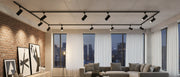 Black track lighting installed in a modern living room